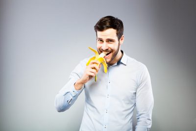 man eating a banana